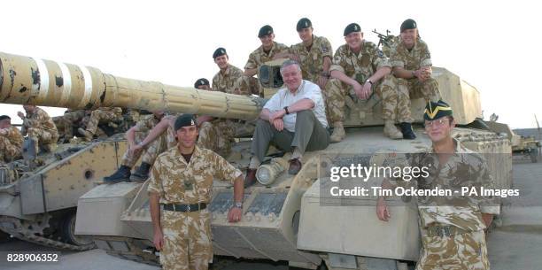 Defence Minister Adam Ingram sits on a Challenger 2 tank with the 6th Troop, D Squadron of the Queen's Royal Hussars, at their base in the...