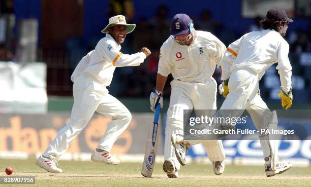 England's Graham Thorpe is stumped by Sri Lanka's Kumar Sangakkara , for 19 runs, as Hashan Tillakaratne celebrates during the fourth day of the...