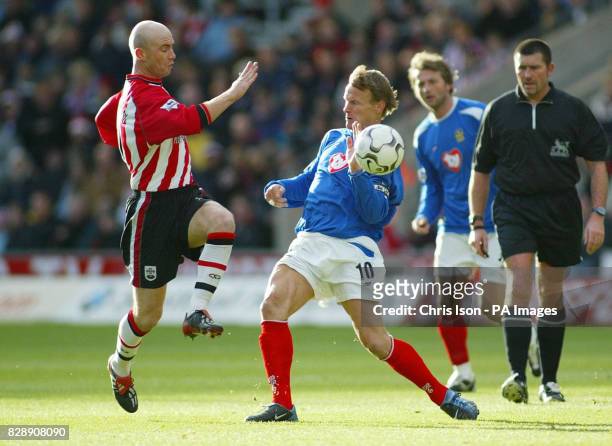 Southampton's Chris Marsden and Portsmouth striker Teddy Sheringham compete for the ball during the Barclaycard Premiership match at the St Mary's...