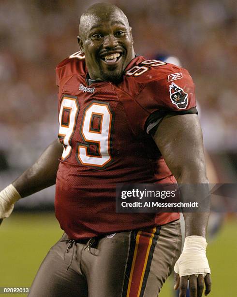 Tampa Bay Buccaneers defensive tackle Warren Sapp plays to the crowd after losing his helmet while rushing November 24, 2003 against the New York...