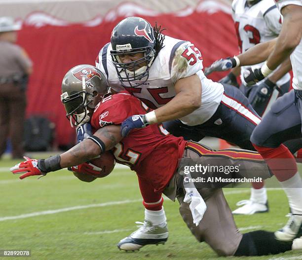 Tampa Bay Buccaneers running back Michael Pittman goes piggy back against the Houston Texans linebacker Jamie Sharper at Raymond James Stadium,...