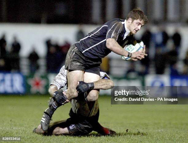 Andy Williams of Neath/Swansea Ospreys is tackled by Trevor Brennan of Toulouse, during tonight's Heineken Cup Pool 2 match at The Gnoll in Neath.