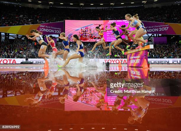 Lennie Waite of Great Britain and others jump the hurdle at water jump as they compete in the Women's 3000 metres Steeplechase heats during day six...