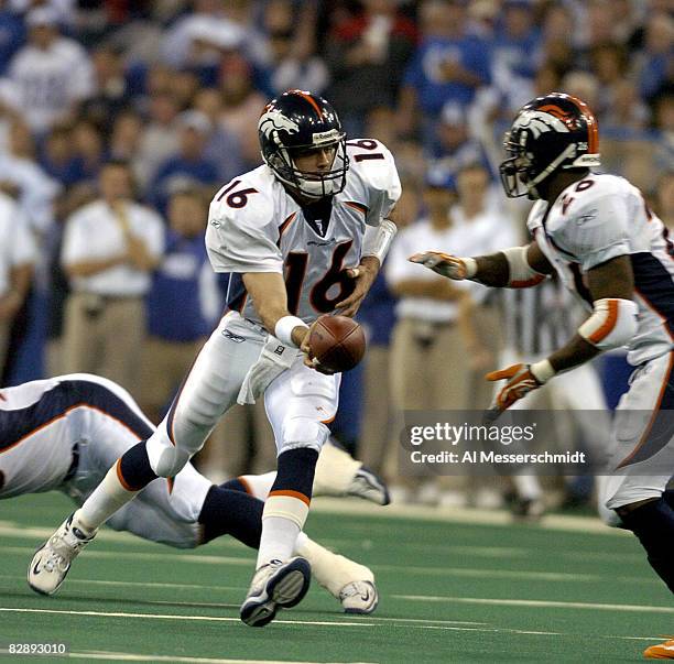 Denver Broncos quarterback Jake Plummer hands off at the RCA Dome, Indianapolis, Indiana, January 4, 2004 in an AFC wildcard playoff game.