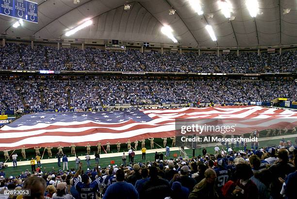 American flag covers the field from endzone to endzone during during pre-game ceremonies January 4, 2004 at the RCA Dome, Indianapolis, in an AFC...