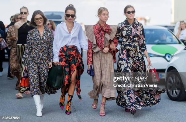 Group of guests wearing dress with floral print outside Stine Goya on August 09, 2017 in Copenhagen, Denmark.