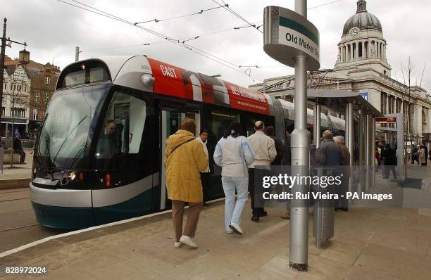 Passengers use the new NET tram system for the first time. The opening of the nine-mile section of track between Hucknall and city centre has been...