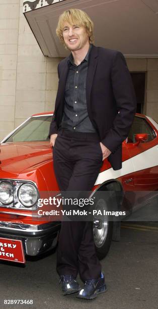 Actor Owen Wilson poses with an original Ford Torino during a photocall at The Dorchester Hotel on Park Lane in London, ahead of the film premiere of...