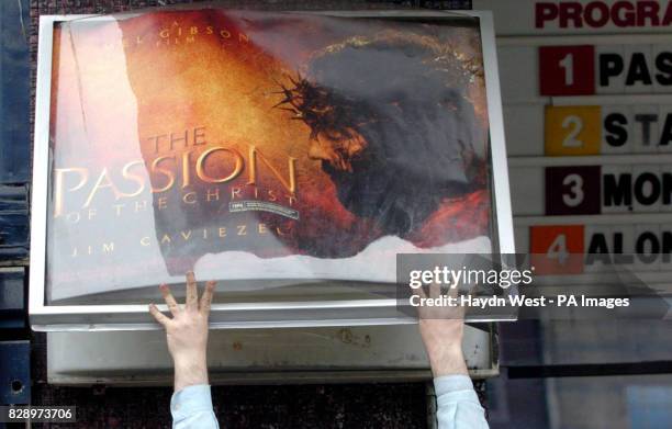 Member of staff replaces the billboard with the poster of Mel Gibson's new film 'The Passion of the Christ' at the Savoy cinema in Dublin, Ireland,...