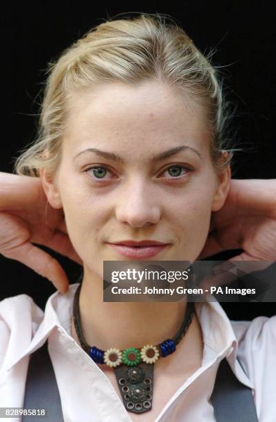 Christie's intern Annika Murjahn, from Freiburg in Germany, models a leather collar as previously worn by John Lennon continuously throughout...