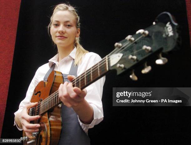 Christie's intern Annika Murjahn, from Freiburg in Germany, picks up a custom-made Vox Kensington guitar given to Alex Mardas by John Lennon, at a...