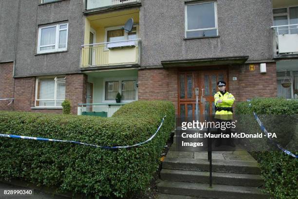 Police officer stands outside a flat in Pollokshields as Police continue their investigation into the abduction and murder of teenager Kriss Donald...