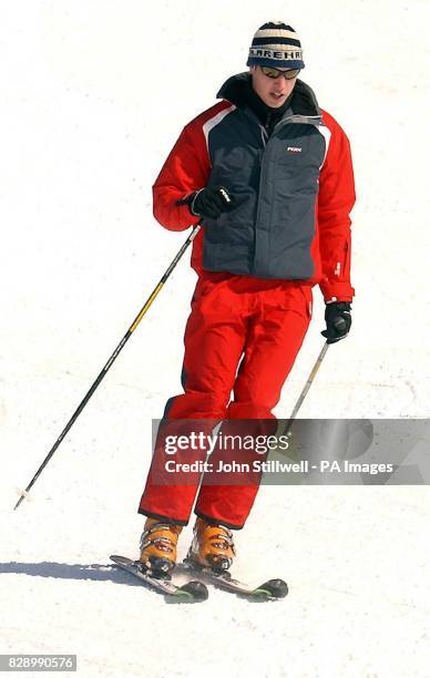 Prince William following close behind his father, the Prince of Wales, as he hurtles down the Madrisa ski slopes, above the Swiss village of...