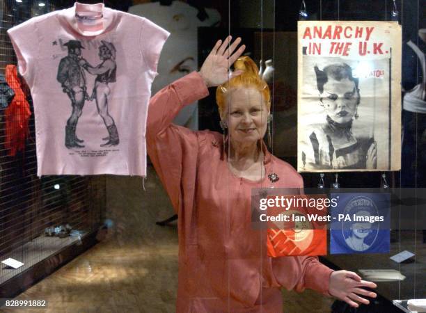 British fashion designer Vivienne Westwood poses with some of her designs during a photocall to mark the opening of the V&A's major Westwood...