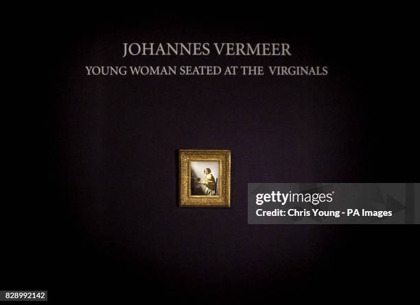 Johannes Vermeer's "Young woman seated at the Virginals" hangs at Sotheby's in central London, after being confirmed as the work of the Dutch master...