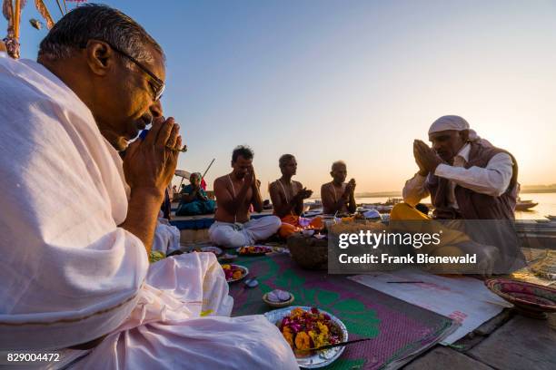 Priest, Brahmin, is working with pilgrims at the holy river Ganges at Dashashwamedh Ghat, Main Ghat, in the suburb Godowlia.