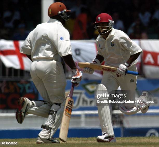 West Indian captain Brian Lara runs with Ridley Jacobs on his way to breaking the world record of 380 runs, during the third day of the 4th Test at...