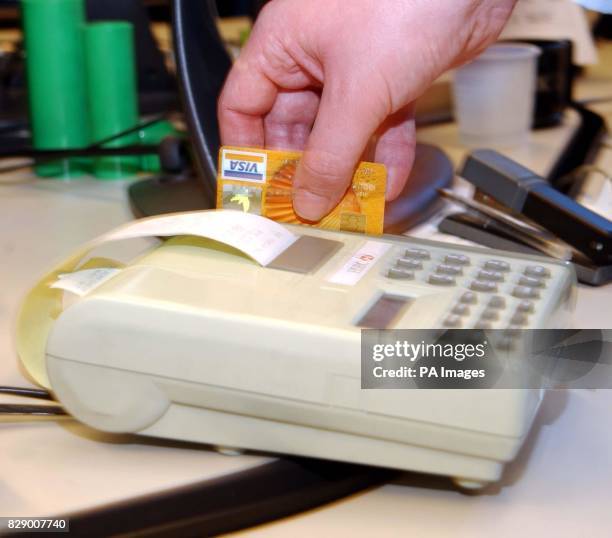 General view of a credit card being swiped through a PDQ paying machine. 19/7/04: Credit card spending looks set to fall during the summer and nearly...