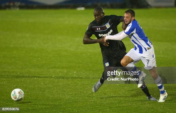 Drey Wright of Colchester United tussle with Aston Villa's Christopher Samba during Carabao Cup First Round match between Colchester United and Aston...