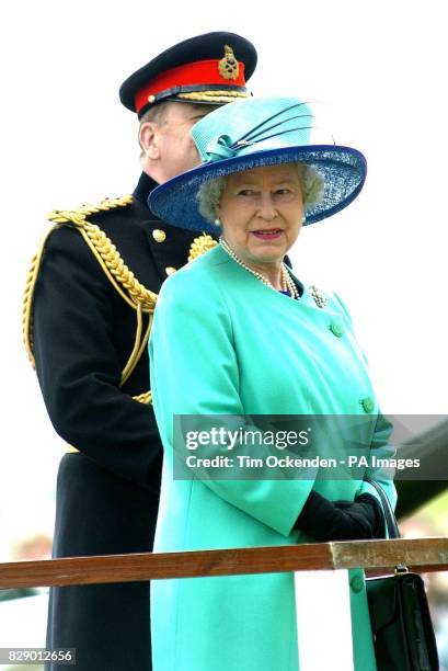 Britain's Queen Elizabeth II with Colonel Commandant, General Sir Timothy Granville-Chapman, watch the Light Cavalry of the Honourable Artillery...