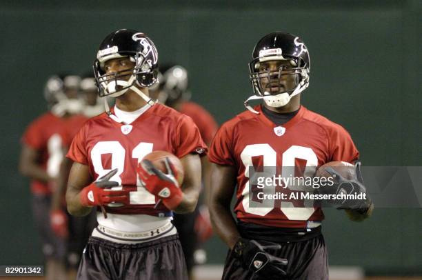 Atlanta Falcons wide receivers Peerless Price and Dez White grab passes during a late-night practice at the Tokyo Dome Aug. 3, 2005 in Japan.