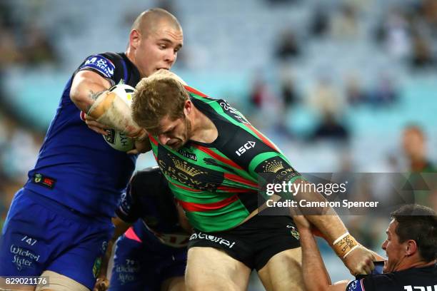 Sam Burgess of the Rabbitohs is tackled during the round 23 NRL match between the South Sydney Rabbitohs and the Canterbury Bulldogs at ANZ Stadium...