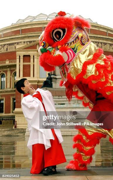 Geoffrey Chang aged 11 from the Choir of Temple Church in the City of London, is startled by the appearance of a Chinese dragon, on the steps of the...