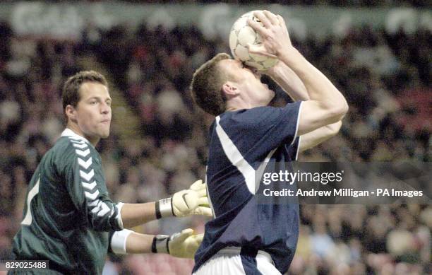 Scotland's striker Kevin Kyke shows his frustration watched by Denmarks goalkeeper Thomas Sorensen during the Denmark vs Scotland international...