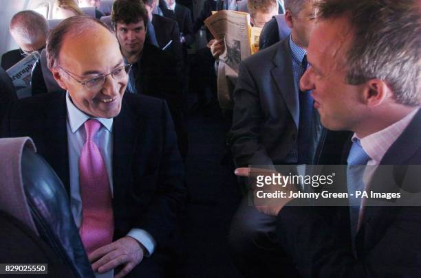 The leader of the Conservative Party Michael Howard shares a joke with ITN's political correspondent John Ray, aboard a flight from Manchester to...