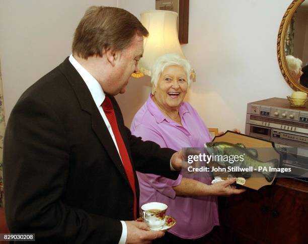 Deputy Prime Minister John Prescott is shown Molly Hammond's 'Billy Bass' singing fish as he visits Molly's council flat in Chelsea West London, as...