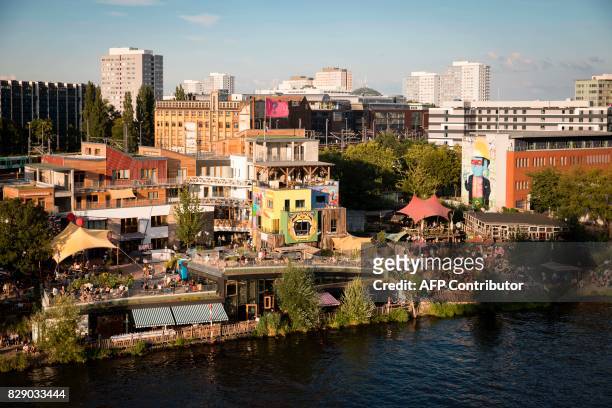General view taken on August 9, 2017 of the urban cooperative project Holzmarkt 25 on the banks of the river Spree in Berlin. The project includes...
