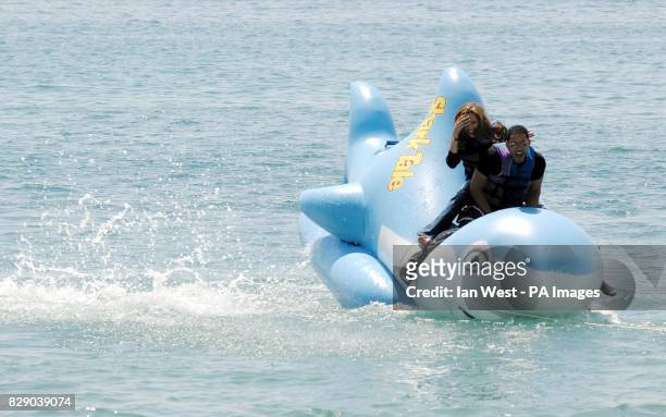 Actors Will Smith and Angelina Jolie laugh as Jack Black leapt into the waters as they rode an inflatable shark during a photocall for the new...