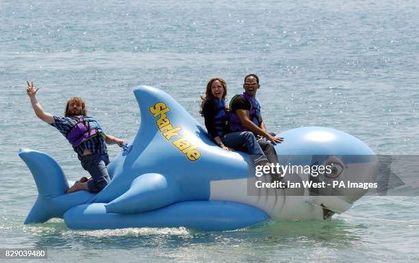 Actors Will Smith , Angelina Jolie and Jack Black ride an inflatable shark during a photocall for the new animated film Shark Tale, where they...