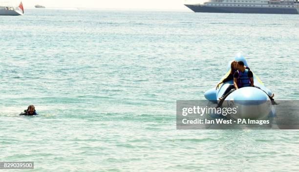 Actor Jack Black in the water after jumping in, as Will Smith and Angelina Jolie look on, as they ride an inflatable shark during a photocall for the...