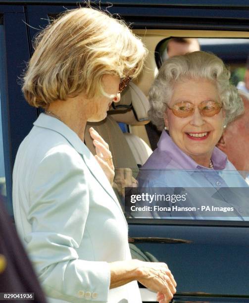 Queen Elizabeth II chats to Lady Romsey as they watch the Duke of Edinburgh competing with the Queen's Fell pony team in the Land Rover International...