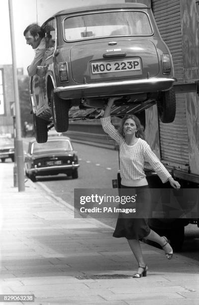 Living up to her super strength image by feigning to lift a Mini suspended above the pavement outside Thames Television's Euston Road studios, is...