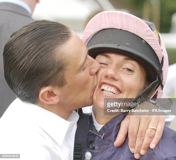 Frankie Dettori kisses his wife Catherine after she won the Cantor Odds Charity Sweepstake Flat Race on Cristoford at Newbury.