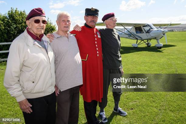 Veterans Ted Pieri , Dick Carpenter , Mike Smith and Fred Glover pose for photographs ahead of their skydive, at the Old Sarum airfield on August 10,...