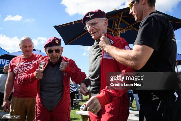 Former paratroopers Ted Pieri and Fred Glover get into their jumpsuits ahead of their skydive at the Old Sarum airfield on August 10, 2017 in...