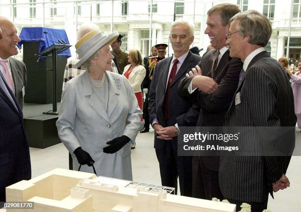 Britian's Queen Elizabeth II smiles with her son Prince Andrew, second right, as architect Lord Norman Foster, left, and Sir Richard Sykes, right,...