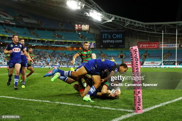 Bryson Goodwin of the Rabbitohs is tackled short of the tryline during the round 23 NRL match between the South Sydney Rabbitohs and the Canterbury...