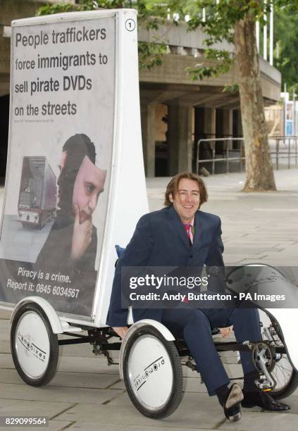 And radio presenter Jonathan Ross poses for photographers during a photocall to launch an industry-wide DVD anti-piracy campaign outside the National...