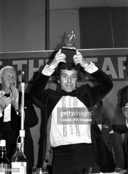 Footballer of the Year 1973-74, Ian Callaghan , holds aloft the trophy at the Football Writers Association Awards dinner at the Bloomsbury Centre...