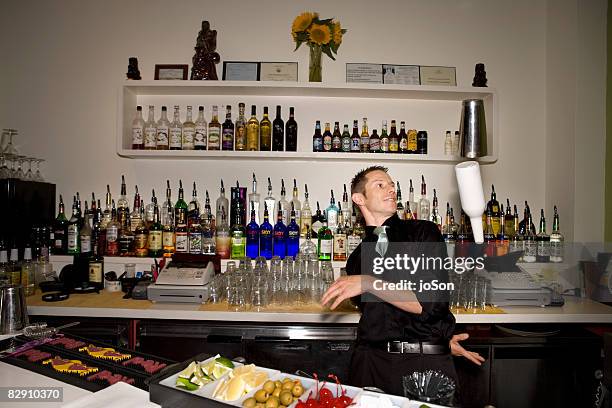 bartender throwing bottle in bar - floating shelves stock pictures, royalty-free photos & images