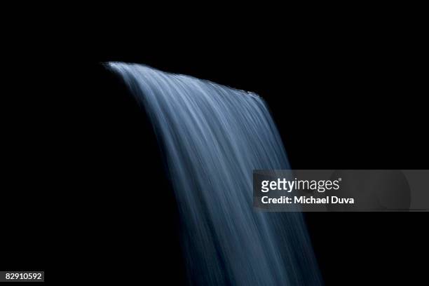 waterfall against black background - waterfall photos et images de collection