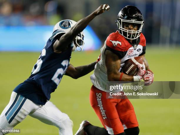 Cassius Vaughn of the Toronto Argonauts goes to tackle Marquay McDaniel of the Calgary Stampeders during a CFL game at BMO Field on August 3, 2017 in...