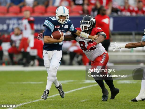 Bryan Hall of the Calgary Stampeders goes to sack Ricky Ray of the Toronto Argonauts during a CFL game at BMO Field on August 3, 2017 in Toronto,...