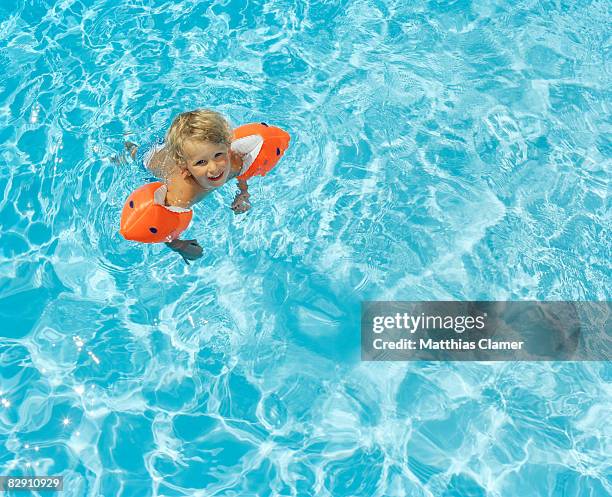 little boy happy learning how to swim - arm band stock pictures, royalty-free photos & images