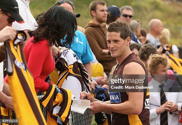 Trent Croad of the Hawks signs autographs for fans during the Hawthorn Football Clubs AFL training session at Waverley Park on September 19, 2008 in...