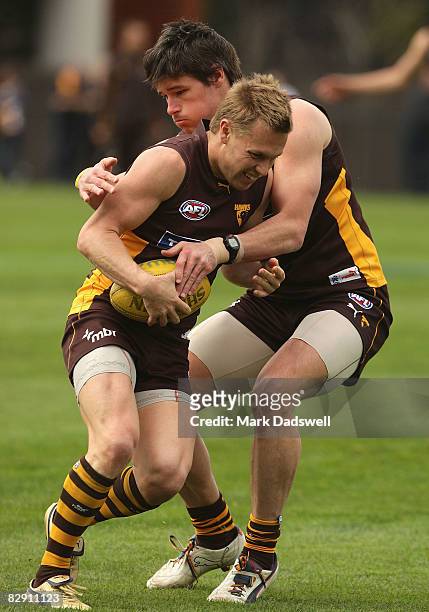 Sam Mitchell of the Hawks is tackled by Robert Campbell during the Hawthorn Football Clubs AFL training session at Waverley Park on September 19,...